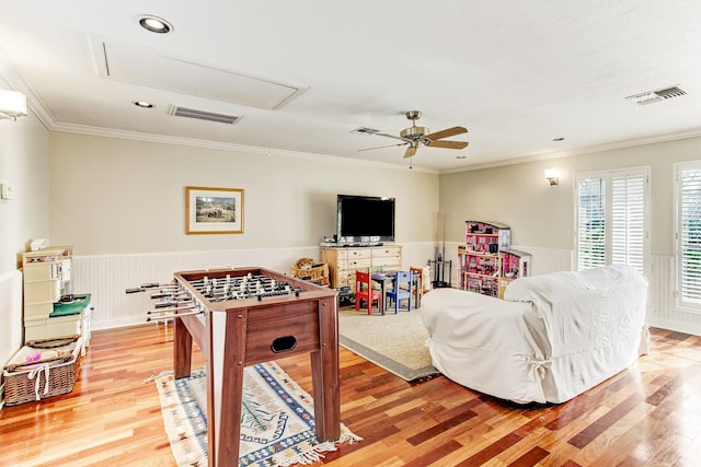 playroom with attic access, visible vents, and wainscoting