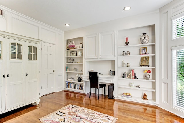 home office with recessed lighting, built in shelves, light wood-type flooring, and ornamental molding