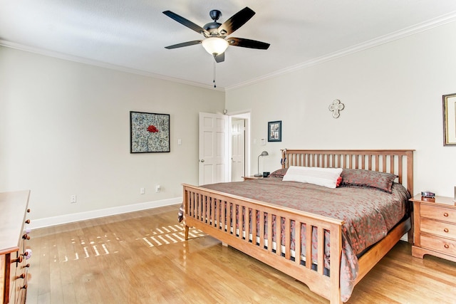 bedroom featuring baseboards, light wood-style floors, and crown molding