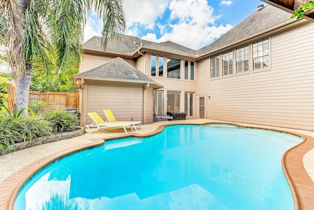 view of swimming pool featuring a fenced in pool, a patio, and fence