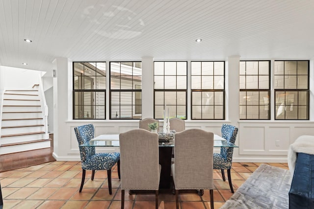 tiled dining room featuring recessed lighting and stairs