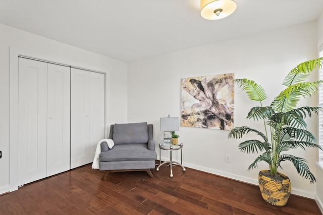 sitting room featuring baseboards and wood finished floors