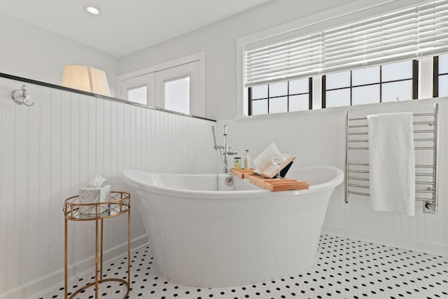 bathroom with tile patterned flooring, a soaking tub, and recessed lighting