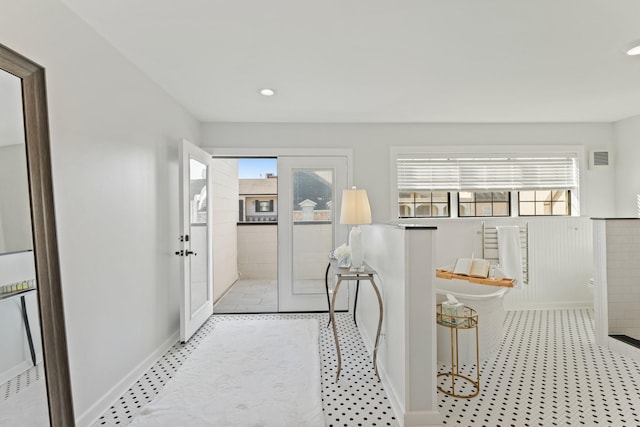 hall featuring recessed lighting, french doors, baseboards, and wainscoting