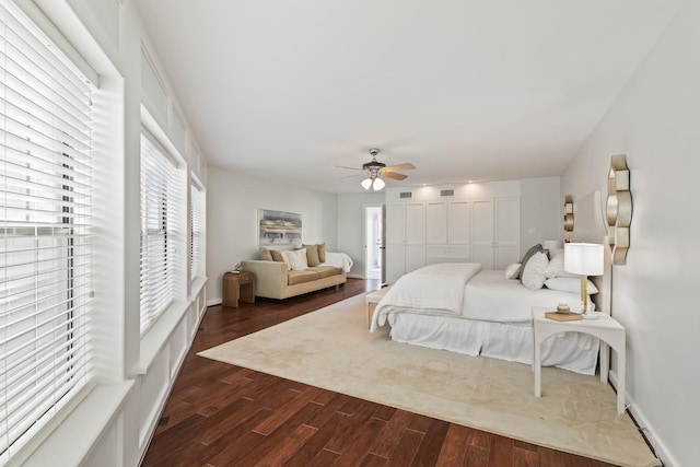 bedroom with visible vents, baseboards, a ceiling fan, and dark wood-style flooring