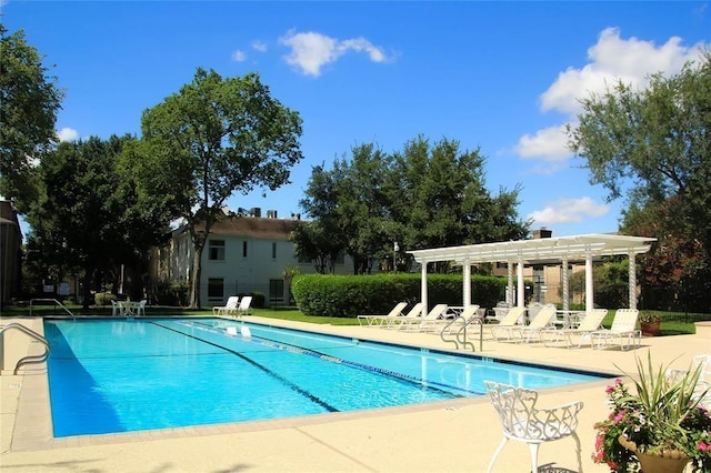 community pool with a pergola and a patio