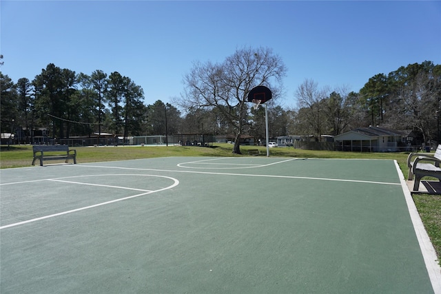 view of basketball court with community basketball court, a yard, and fence