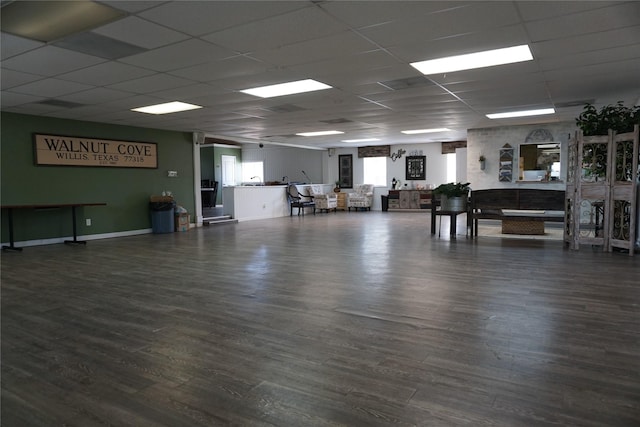 miscellaneous room featuring a drop ceiling, baseboards, and wood finished floors