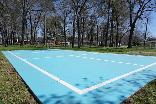 view of property's community featuring playground community, a yard, and community basketball court