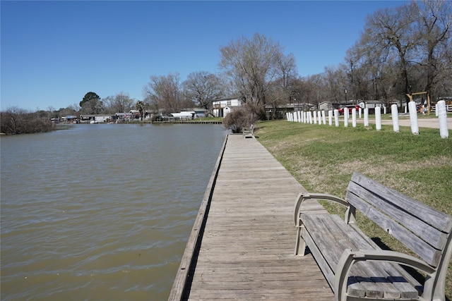 dock area featuring a yard and a water view