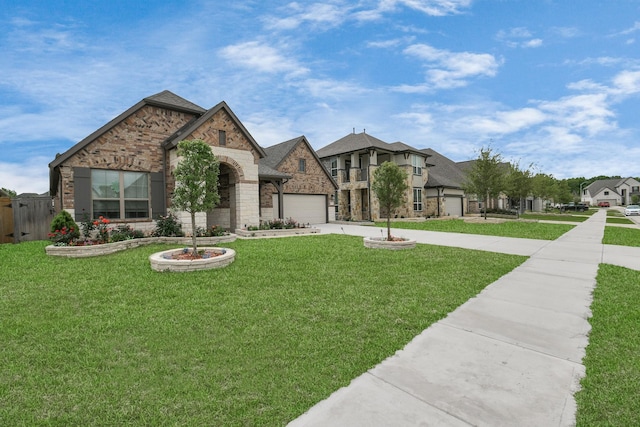 french country style house featuring brick siding, a front lawn, concrete driveway, a garage, and stone siding