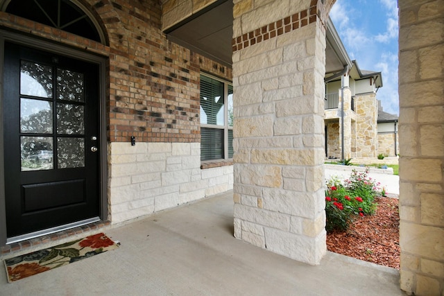 property entrance with brick siding and stone siding