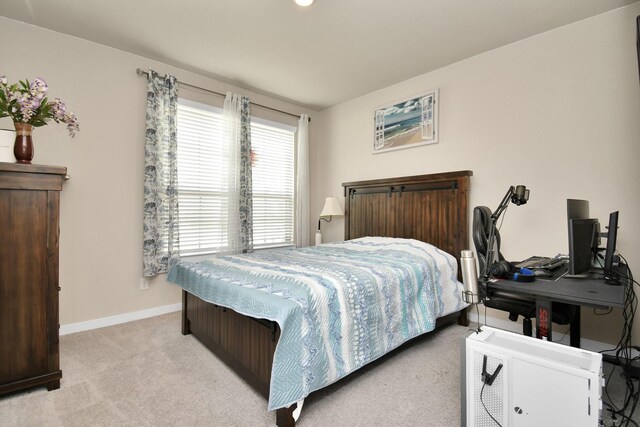 carpeted bedroom featuring baseboards