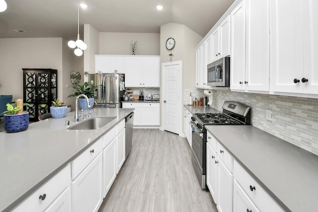 kitchen featuring a sink, white cabinets, and stainless steel appliances