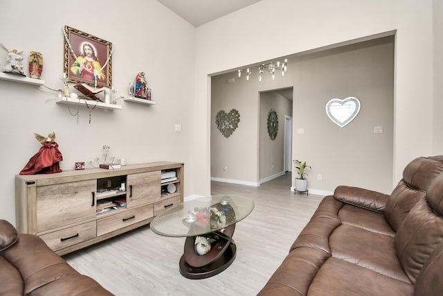 living room with baseboards and light wood-style flooring