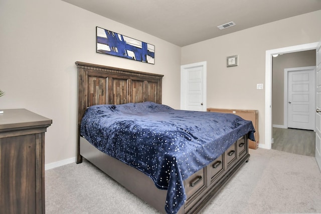 bedroom featuring baseboards, visible vents, and light carpet