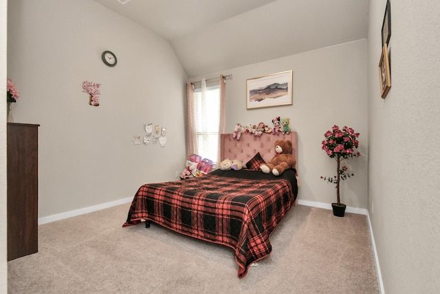 carpeted bedroom with baseboards and vaulted ceiling