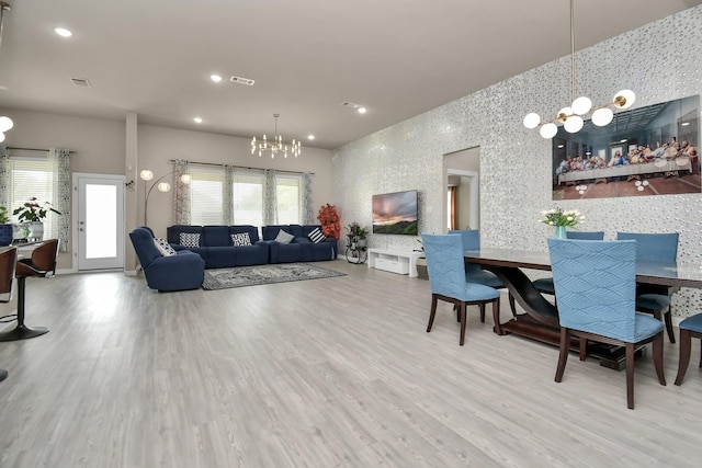 living room with a notable chandelier, recessed lighting, visible vents, and wood finished floors