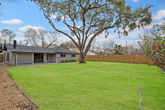 view of yard with a patio and fence