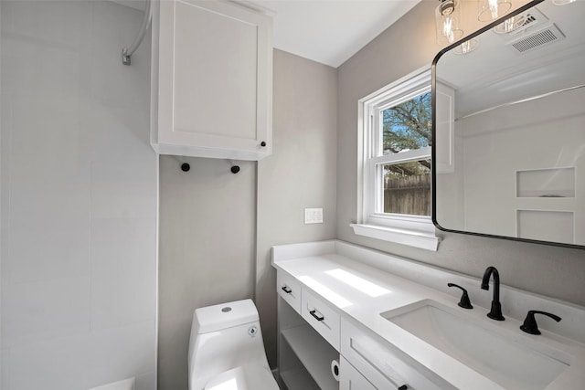 interior space featuring vanity, toilet, and visible vents