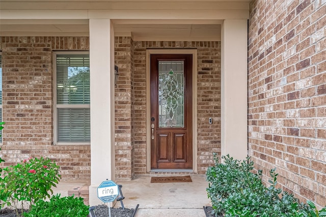 entrance to property with brick siding