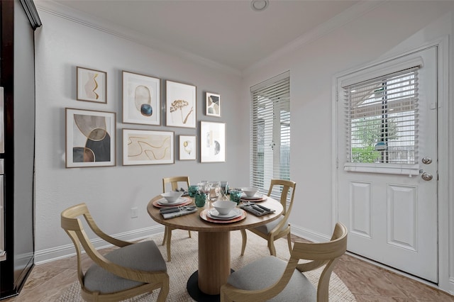 dining space with baseboards and ornamental molding