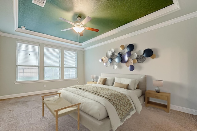 bedroom with visible vents, a raised ceiling, carpet, and crown molding