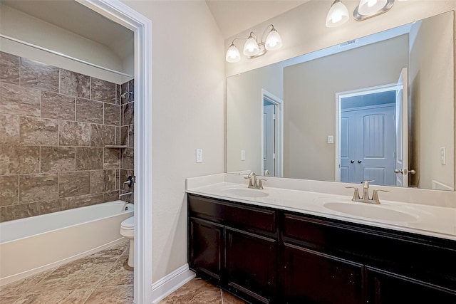 bathroom featuring a sink, toilet, shower / washtub combination, and double vanity