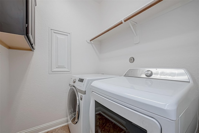 laundry area featuring washer and dryer, laundry area, and baseboards