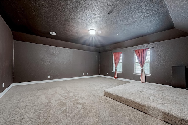 interior space with baseboards, a textured ceiling, and a textured wall