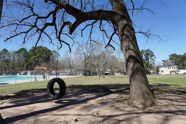 surrounding community with a yard and fence