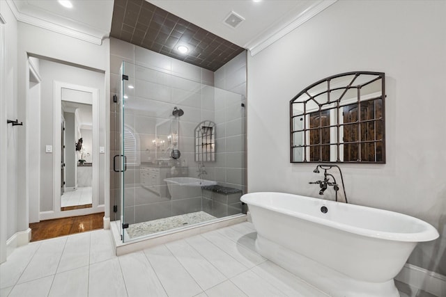 bathroom with tile patterned floors, visible vents, a stall shower, crown molding, and a soaking tub