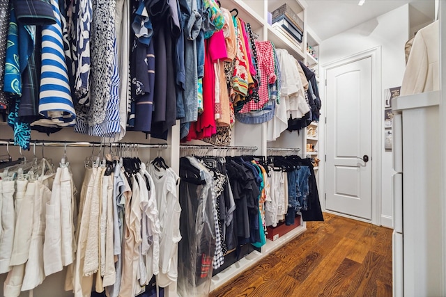 walk in closet with wood finished floors