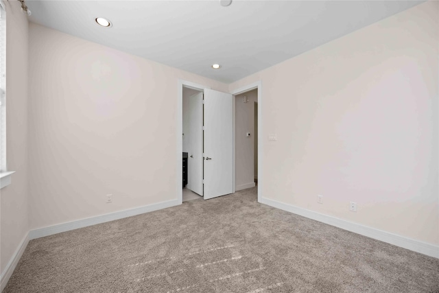 carpeted empty room with recessed lighting and baseboards