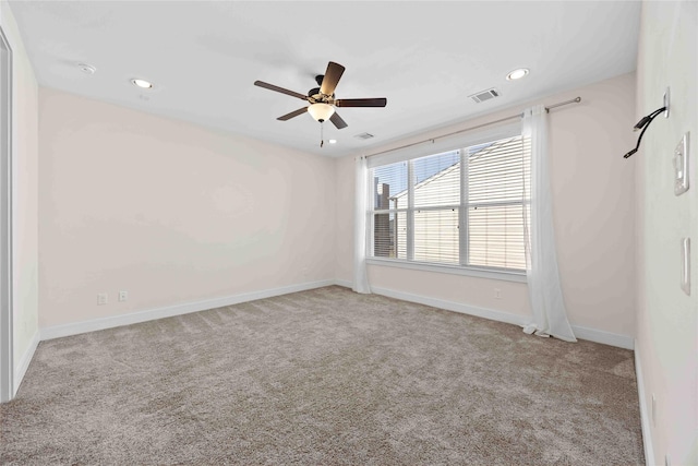 carpeted empty room featuring recessed lighting, baseboards, visible vents, and ceiling fan