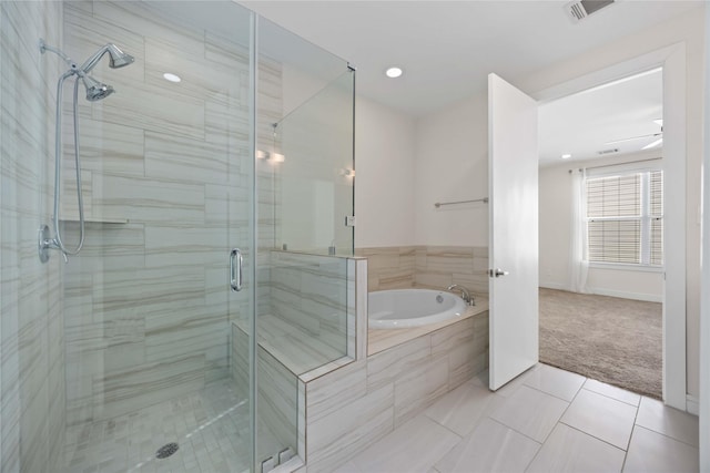 bathroom featuring tile patterned flooring, visible vents, a shower stall, baseboards, and a bath