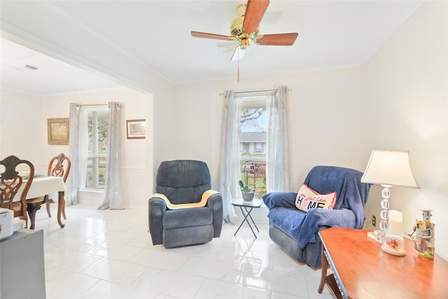 sitting room with visible vents, plenty of natural light, ceiling fan, and crown molding