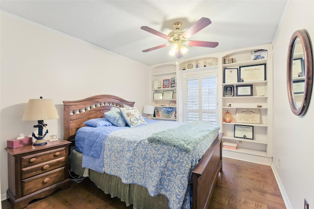 bedroom with ceiling fan, baseboards, and dark wood-style flooring