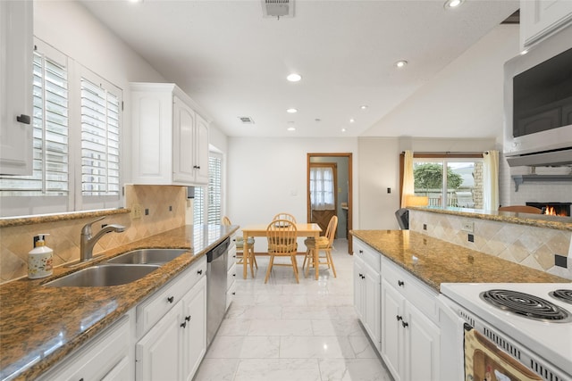 kitchen featuring visible vents, appliances with stainless steel finishes, white cabinets, marble finish floor, and a sink