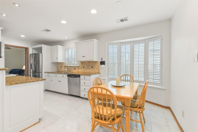 kitchen featuring visible vents, marble finish floor, appliances with stainless steel finishes, and baseboards