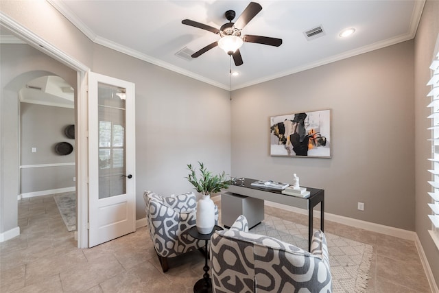 office space featuring visible vents, baseboards, ornamental molding, arched walkways, and a ceiling fan