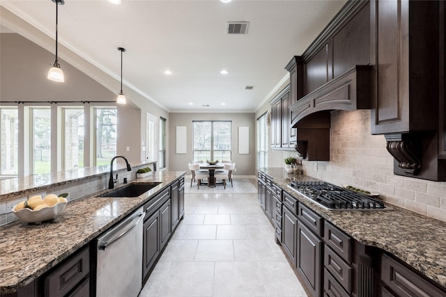 kitchen featuring visible vents, ornamental molding, stainless steel appliances, a sink, and backsplash