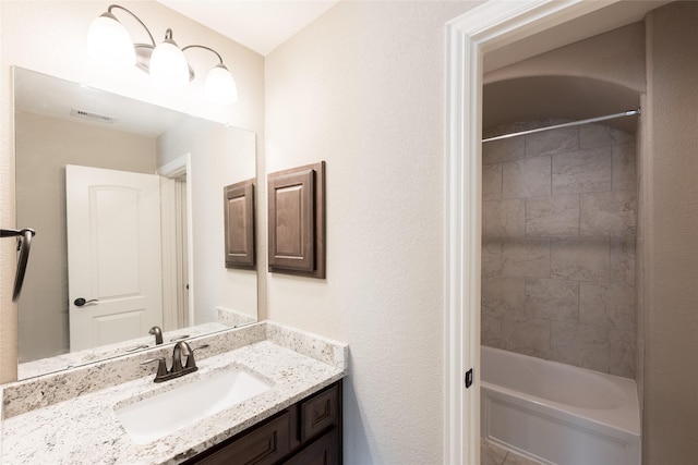 bathroom with visible vents, vanity, and bathing tub / shower combination