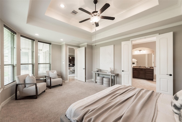 bedroom featuring arched walkways, visible vents, light carpet, and a raised ceiling