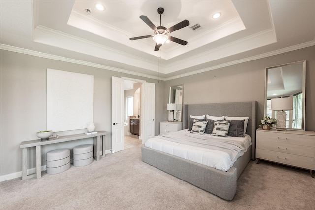 bedroom with visible vents, crown molding, a raised ceiling, and carpet