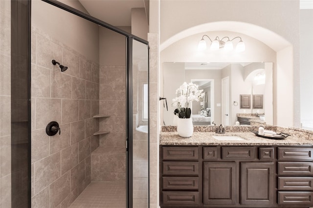 ensuite bathroom featuring ensuite bath, a shower stall, and vanity