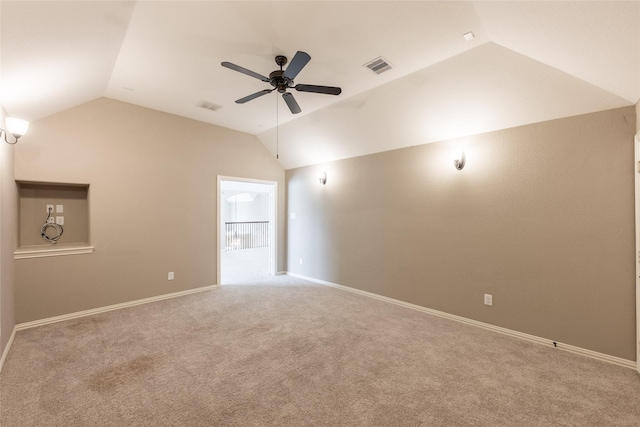 empty room with visible vents, carpet, a ceiling fan, and vaulted ceiling