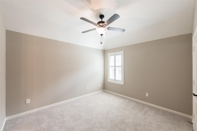 unfurnished room featuring light carpet, baseboards, ceiling fan, and vaulted ceiling