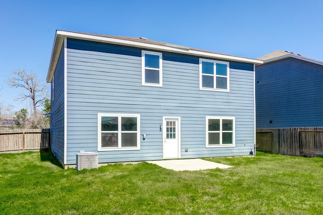 rear view of property with a yard and a fenced backyard