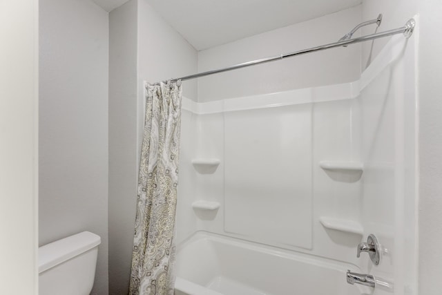 full bath with toilet and shower / bath combo with shower curtain